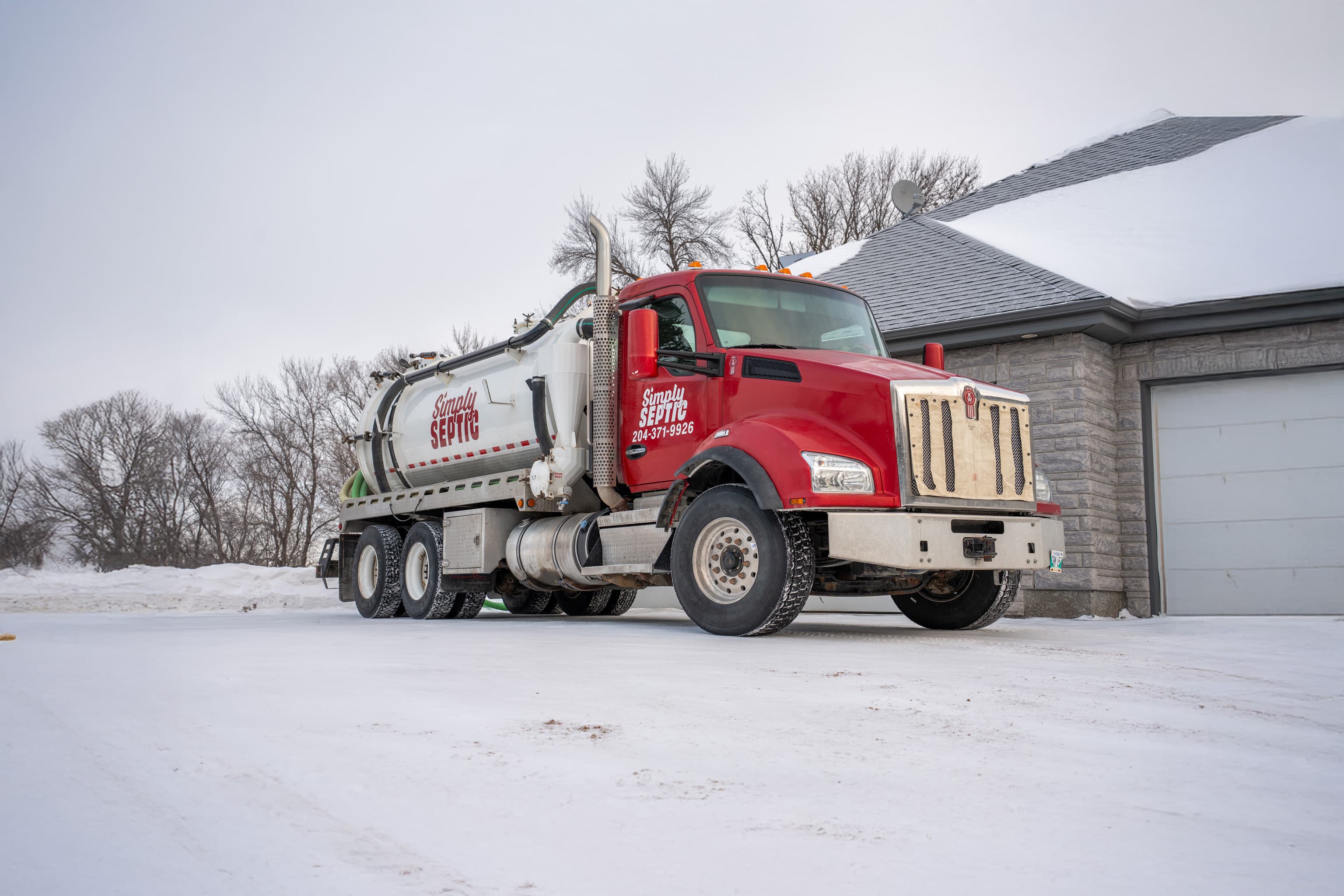 Simply Septic red Kenworth septic service truck